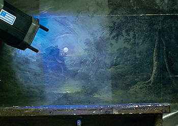 UV light inspecting a painting